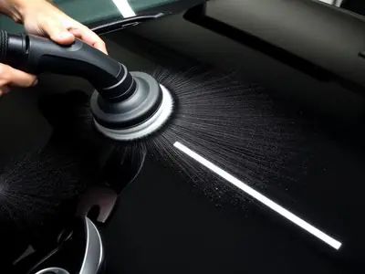 Dual-action polisher machine correcting swirl marks out of dark car paint during a paint correction service